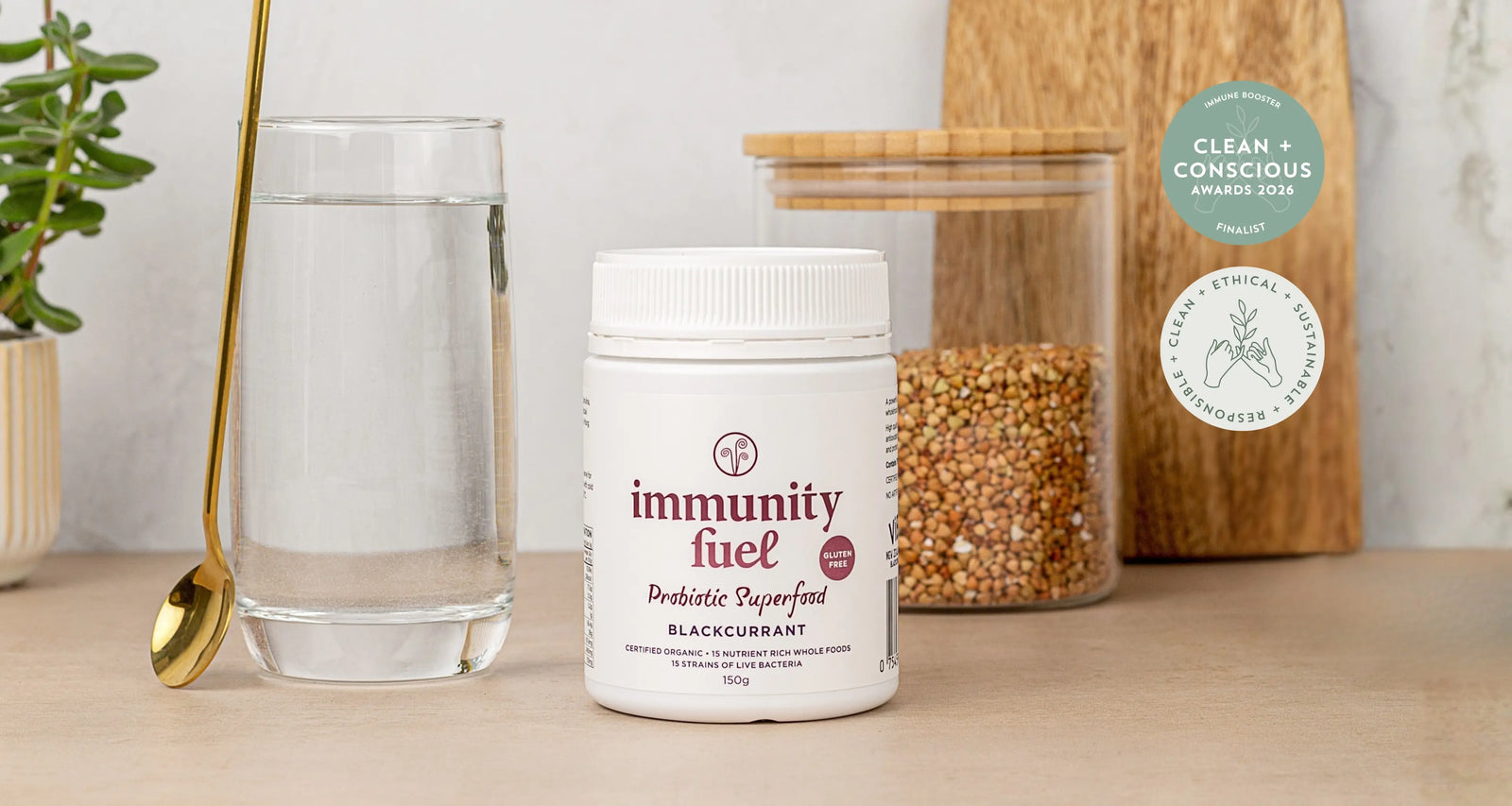 Jar of 'immunity fuel' on a table with a glass of water and a cutting board in the background.